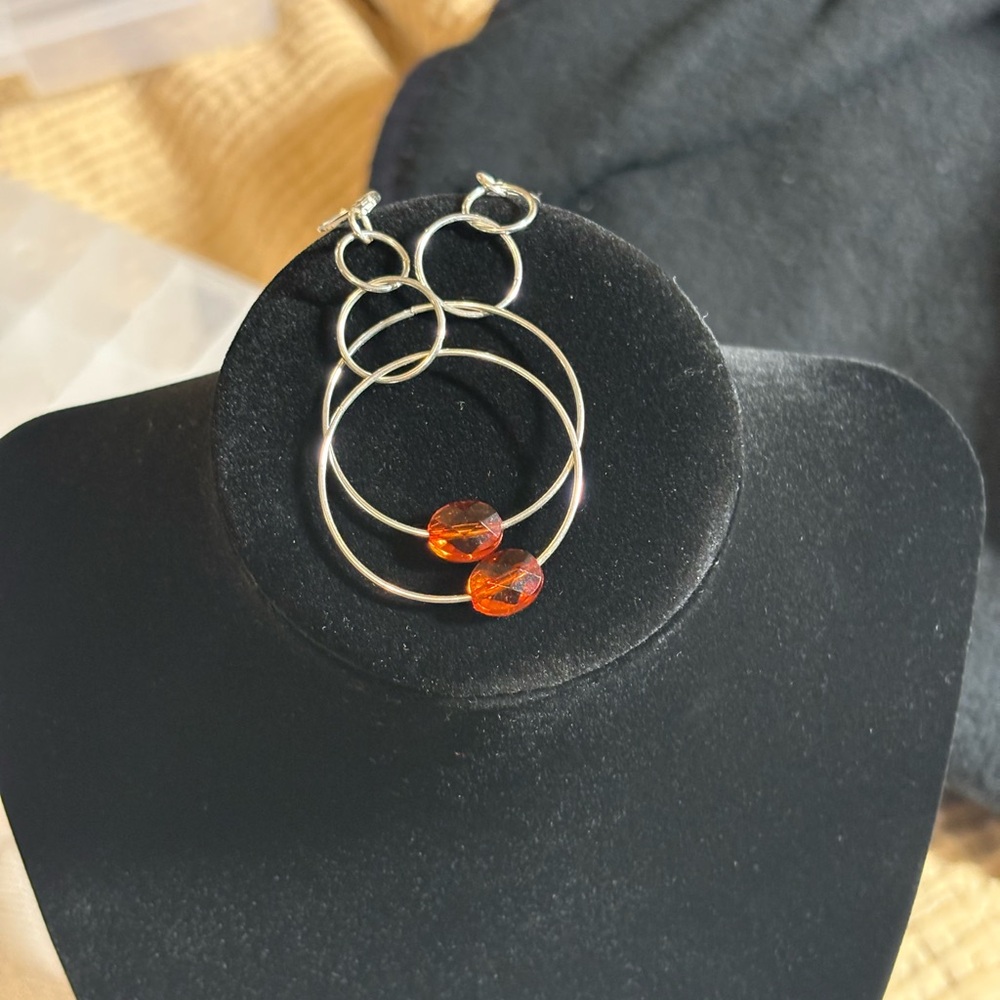 Beautiful minimalist silver tone hoops with a single light refracting crystal!